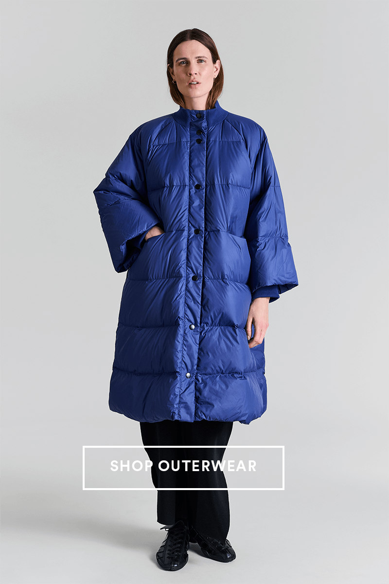 Model wearing a blue Bitte Kai Rand coat. Button text: shop outerwear