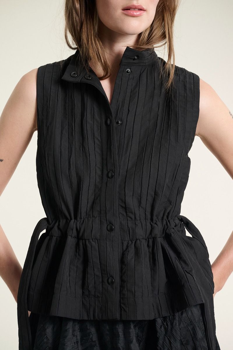 Black sleeveless vest from BITTE KAI RAND with button front, high collar and tie detail at the waist
